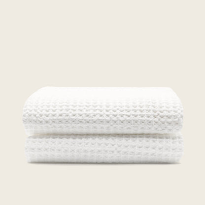 Australian cotton waffle towels in white, neatly folded with waffle pattern