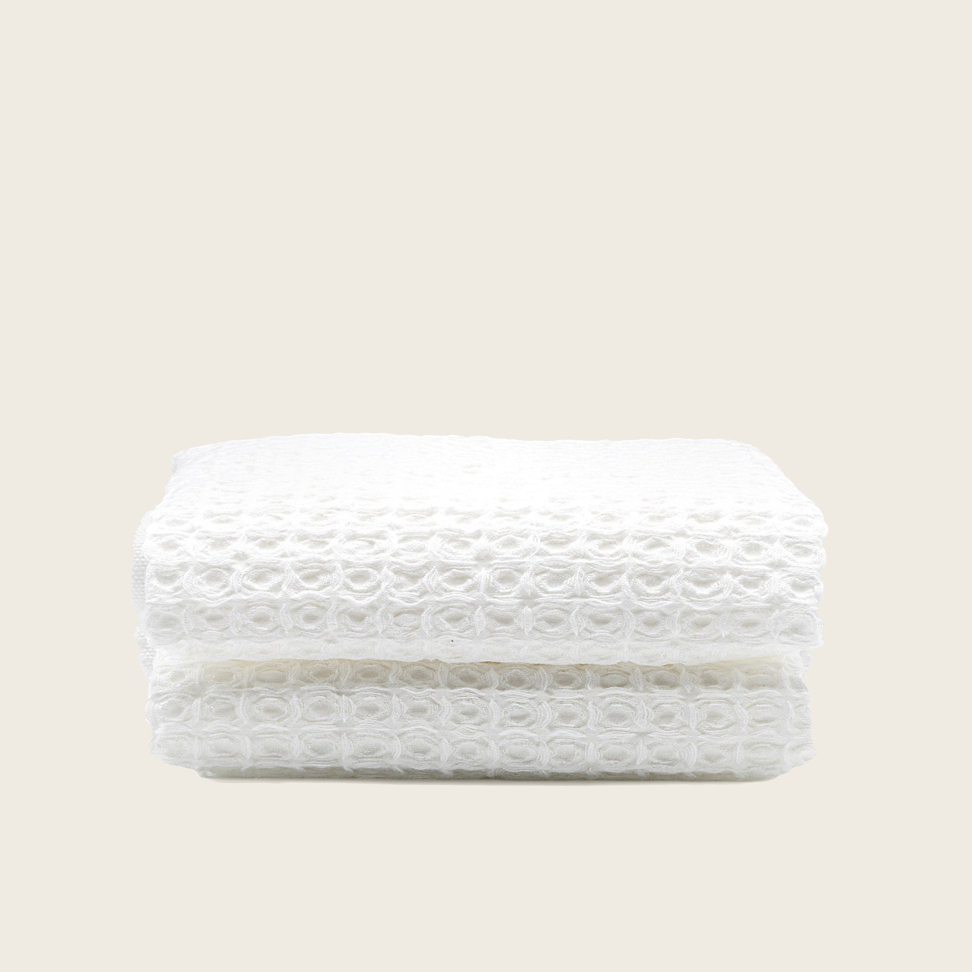 Australian cotton waffle towels in white, folded with textured waffle surface