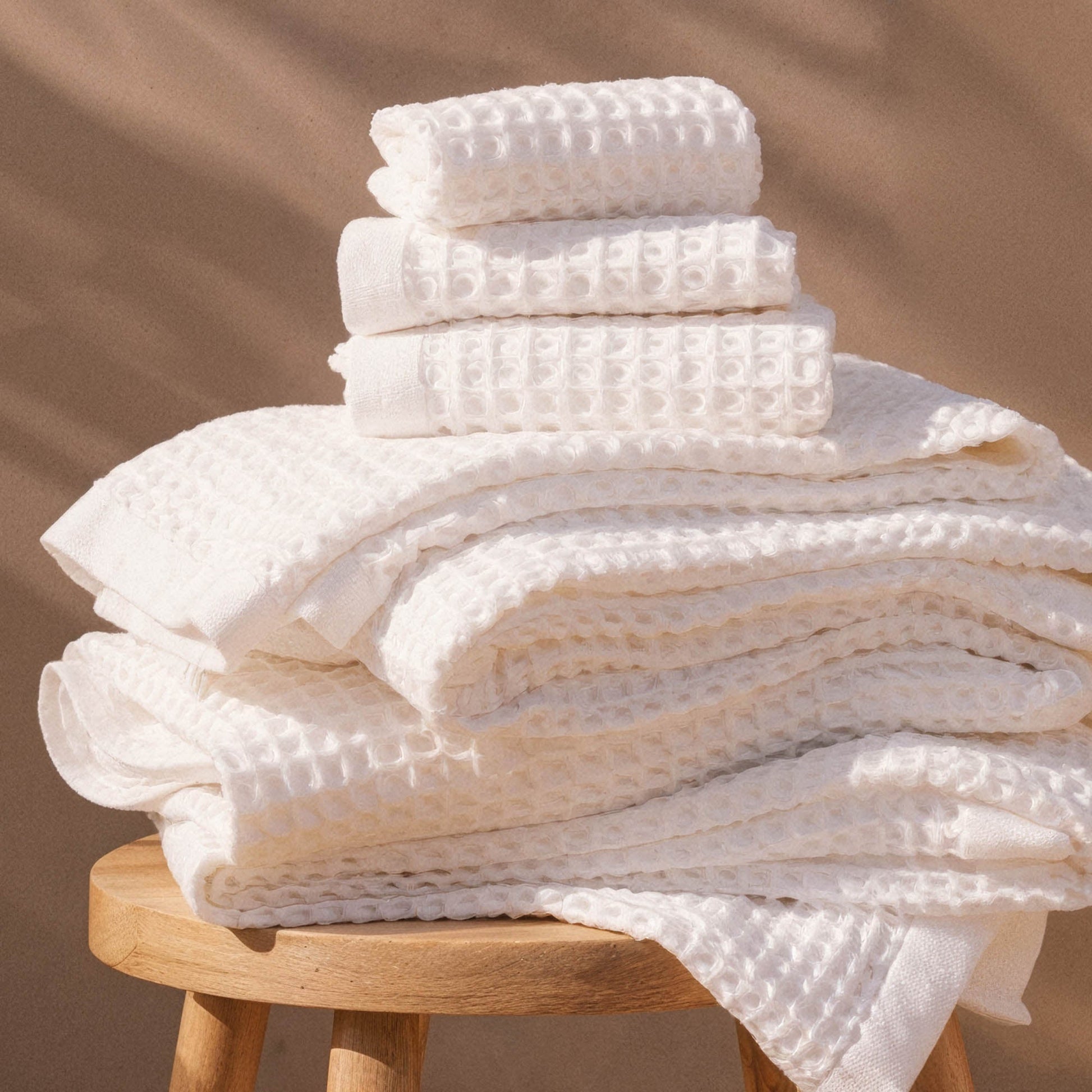 Australian cotton waffle towels in white, stacked in a neat pile