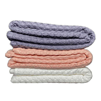 Charcoal gray waffle weave bath towel stack with coral and white.