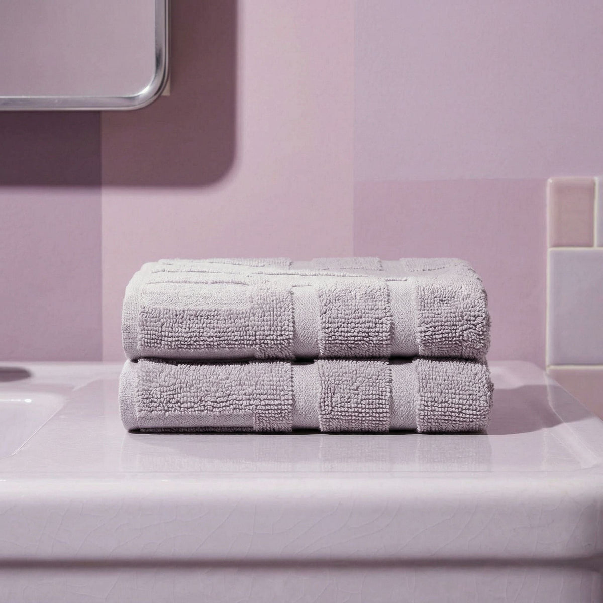 Lilac cotton towels folded with matching striped bands