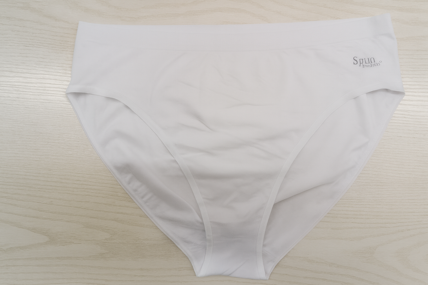 Women's high-leg brief underwear in white, folded flat