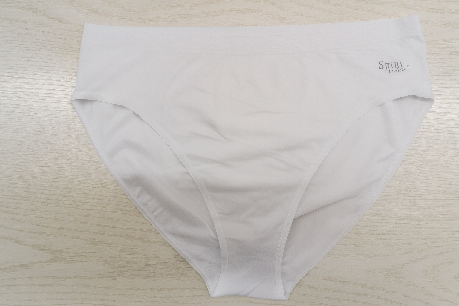 Women's high-leg brief underwear in white, folded flat
