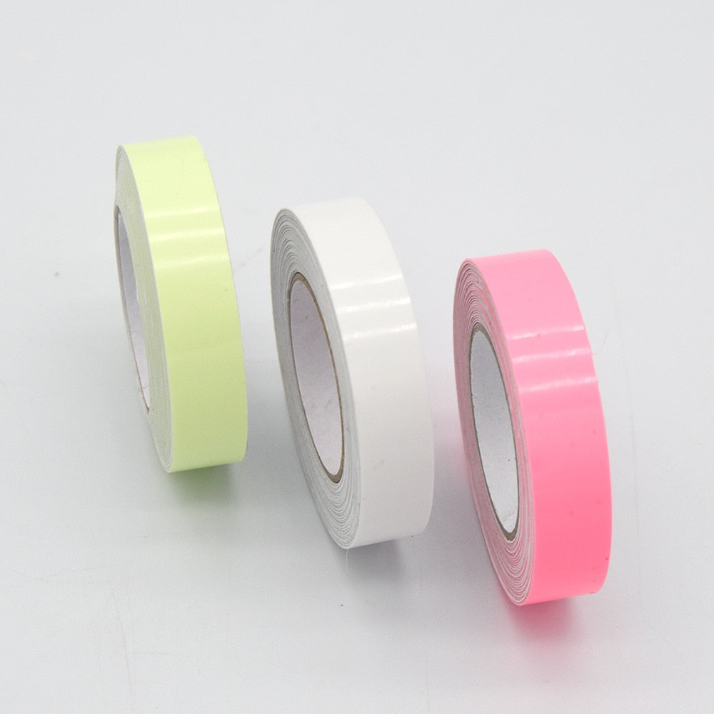 Glow-in-the-dark sticker tape rolls in light green, white, and pink