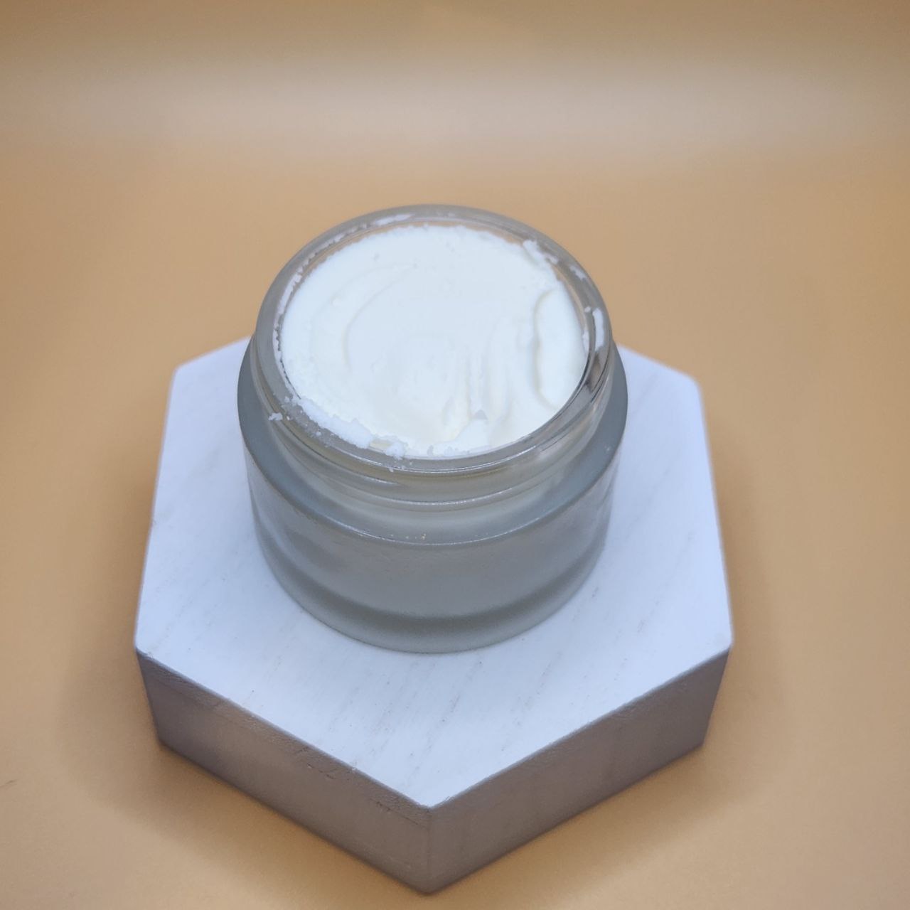 Open tallow balm jar filled with smooth white balm