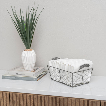 Flour sack napkins, white, folded stack in a woven storage basket