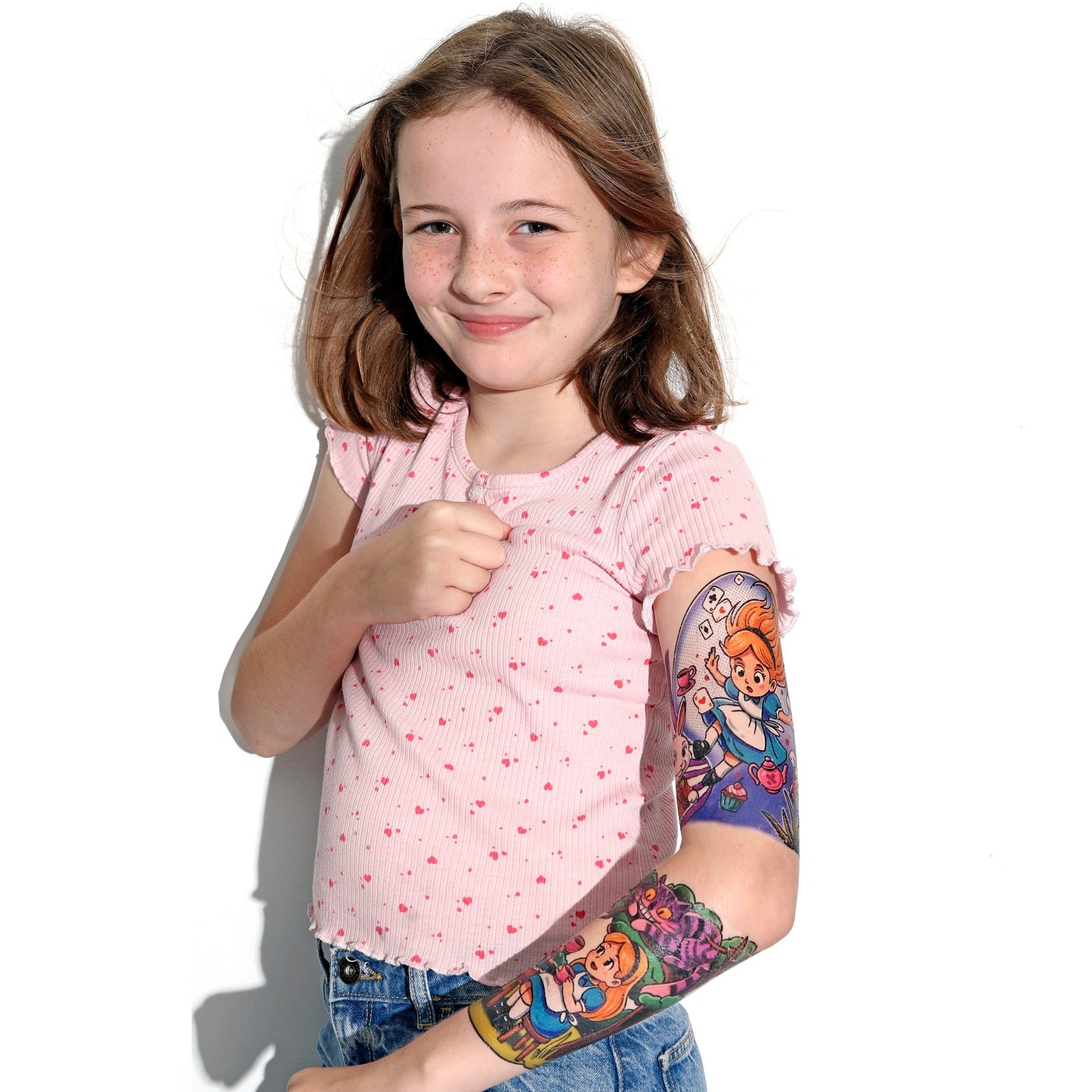 Kids temporary tattoo sleeve on arm, showing colorful wonderland characters and tea set