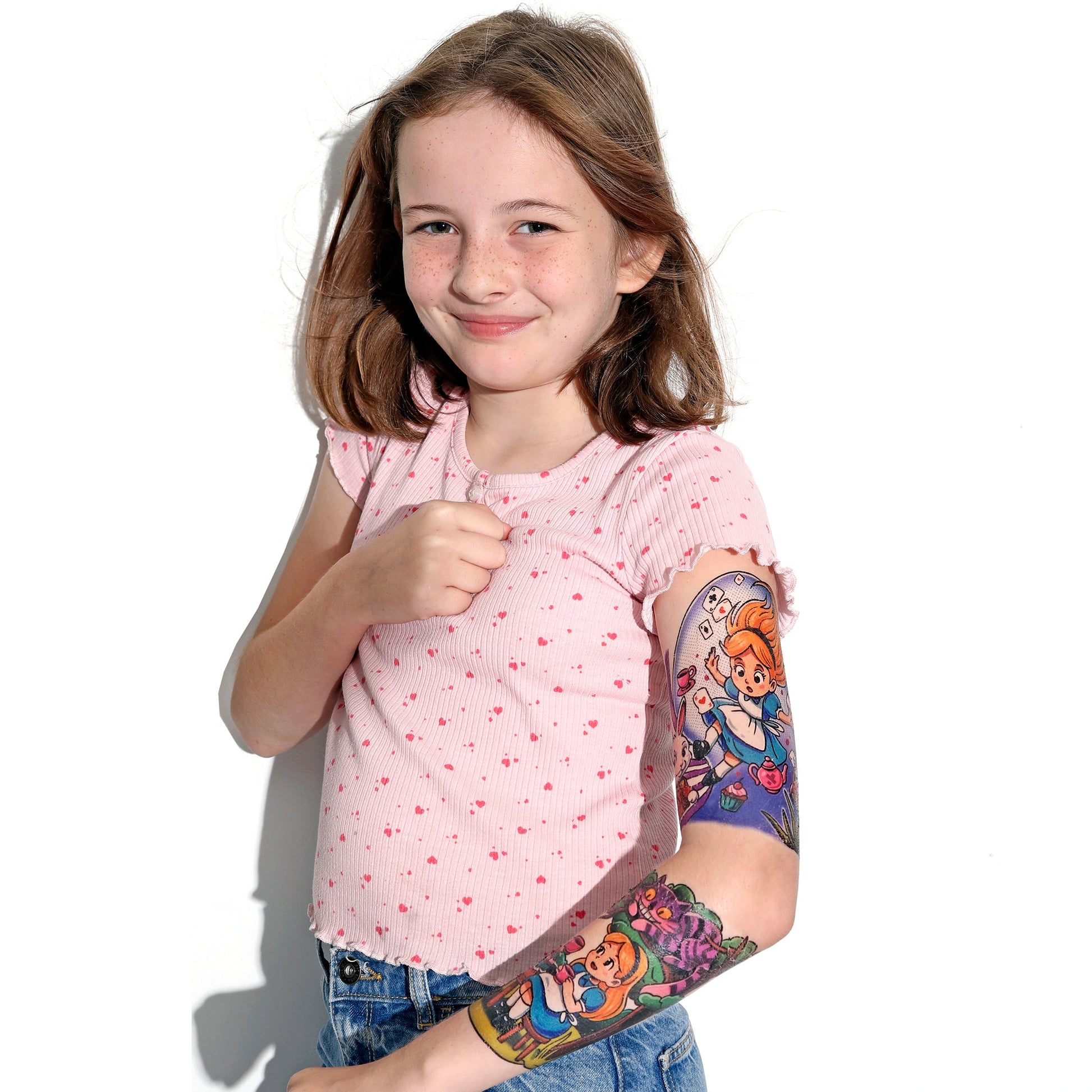 Kids temporary tattoo sleeve on arm, showing colorful wonderland characters and tea set