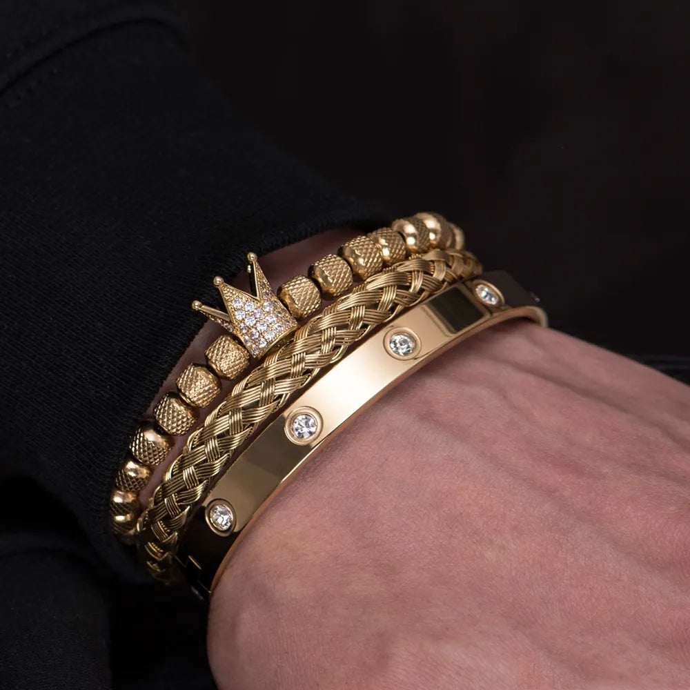 Gold Roman bracelet with braided bands, diamond studs, and crown charm