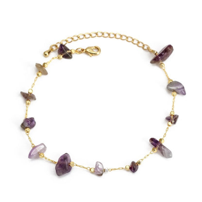 Gold charm bracelet with purple butterfly charms and gold bead accents, secure clasp