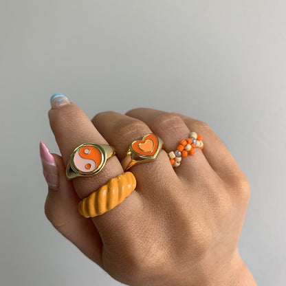 Heart enamel ring with orange heart inset on gold-tone band
