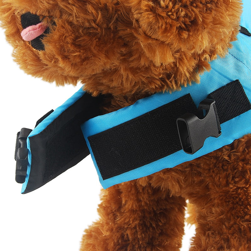 Dog life vest in blue with black strap and front D-ring hardware detail