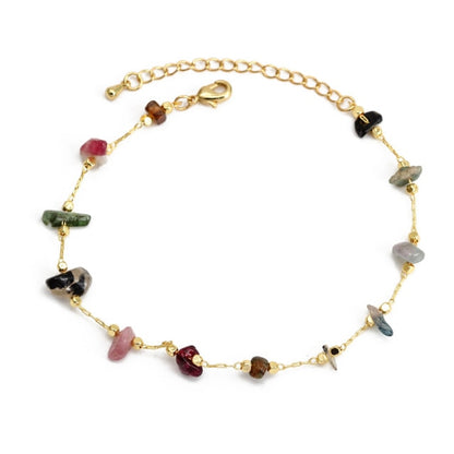 Gold charm bracelet with mixed gemstone charms in pink, black, and green, plus clasp